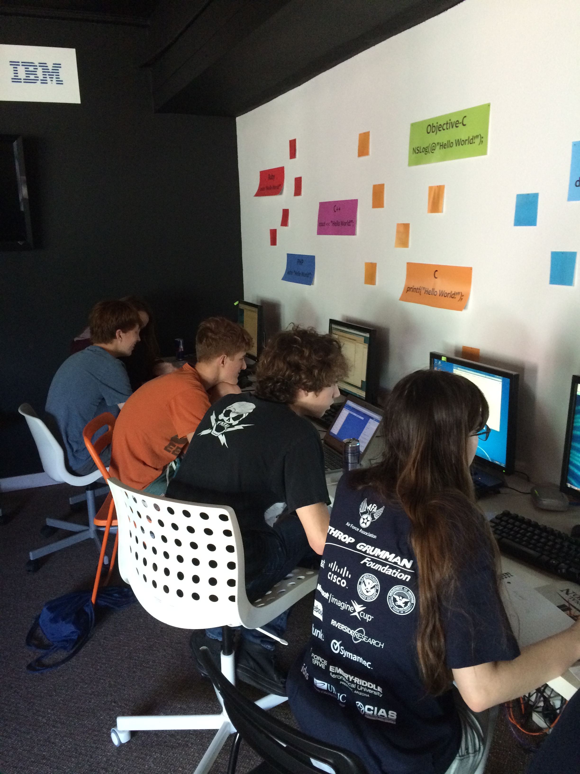 Photo of Codecraft Works' US CyberPatriots team members learning at the computer befor competition.