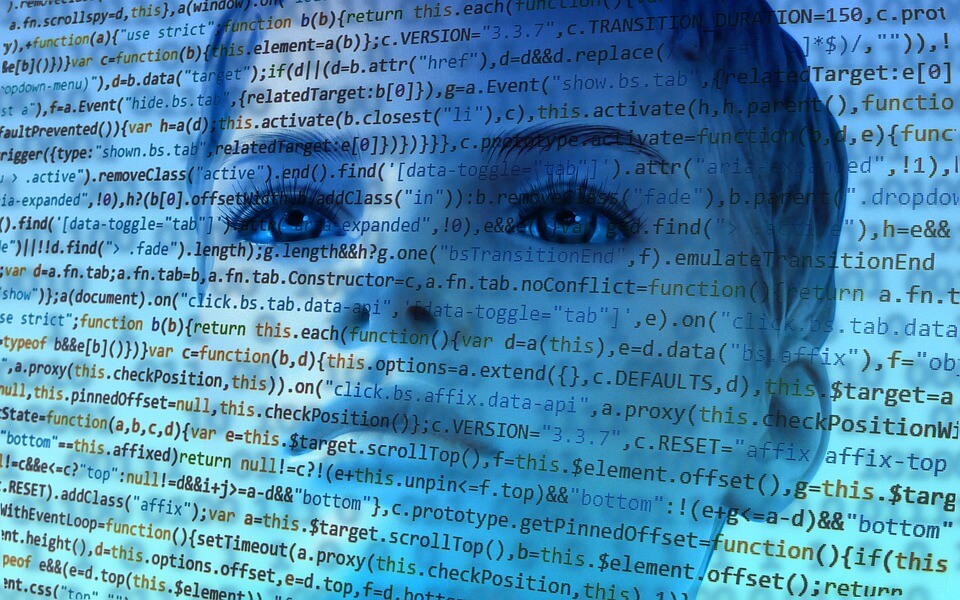 A person's face overlaid by code with a blue filter over the whole image